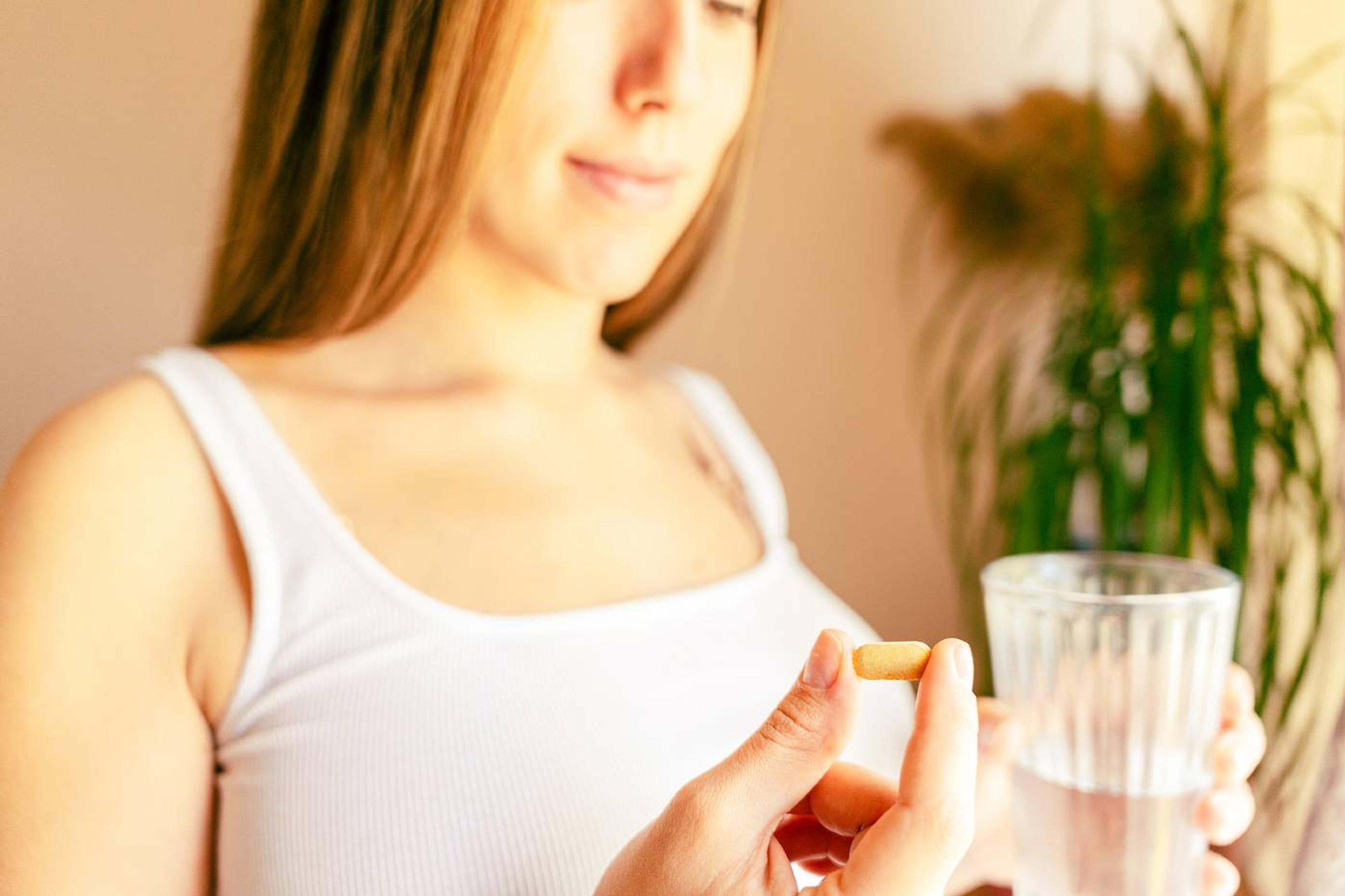 postpartum mom eating encapsulated placenta pill
