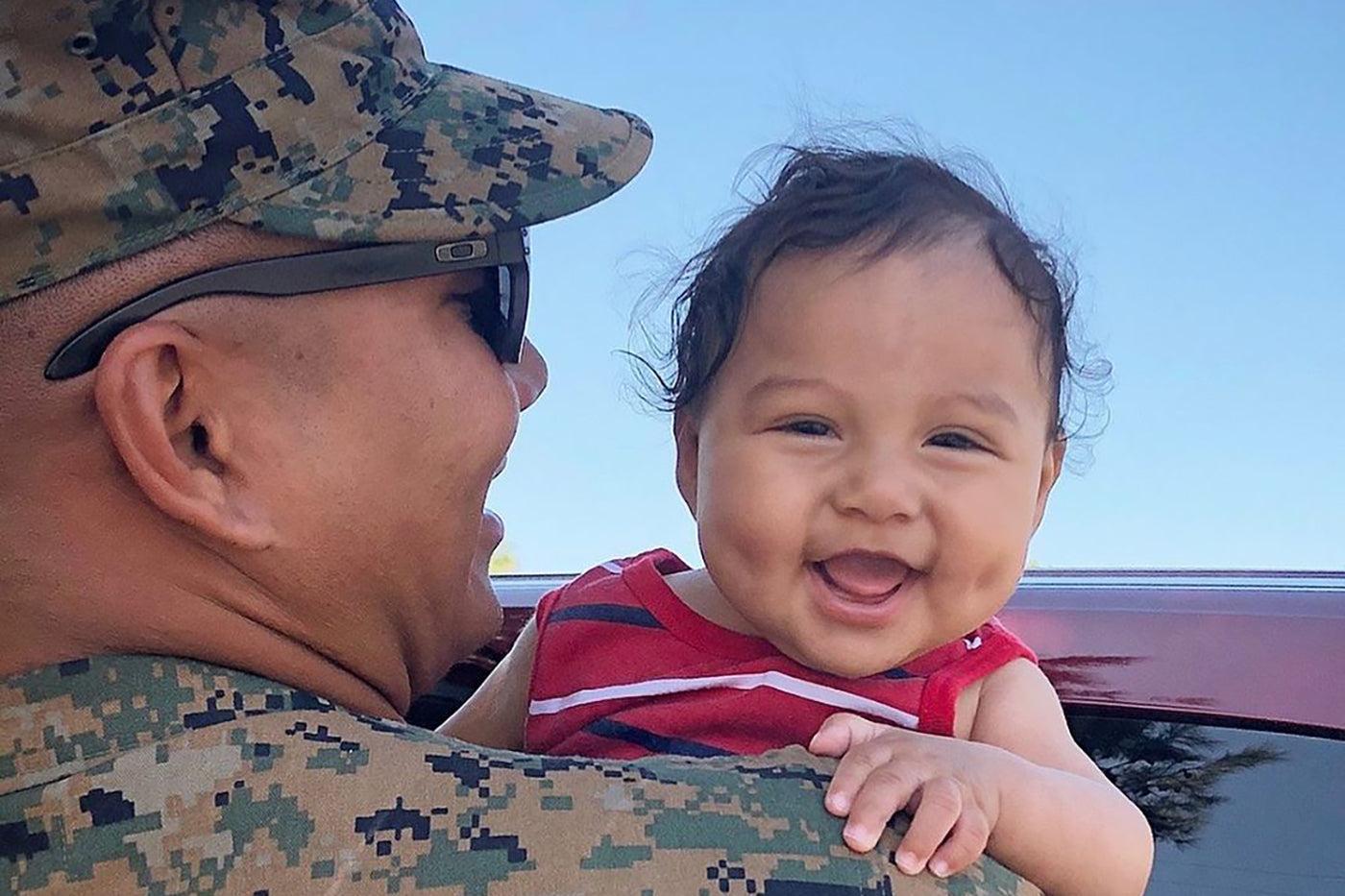 military-dad-holding-baby