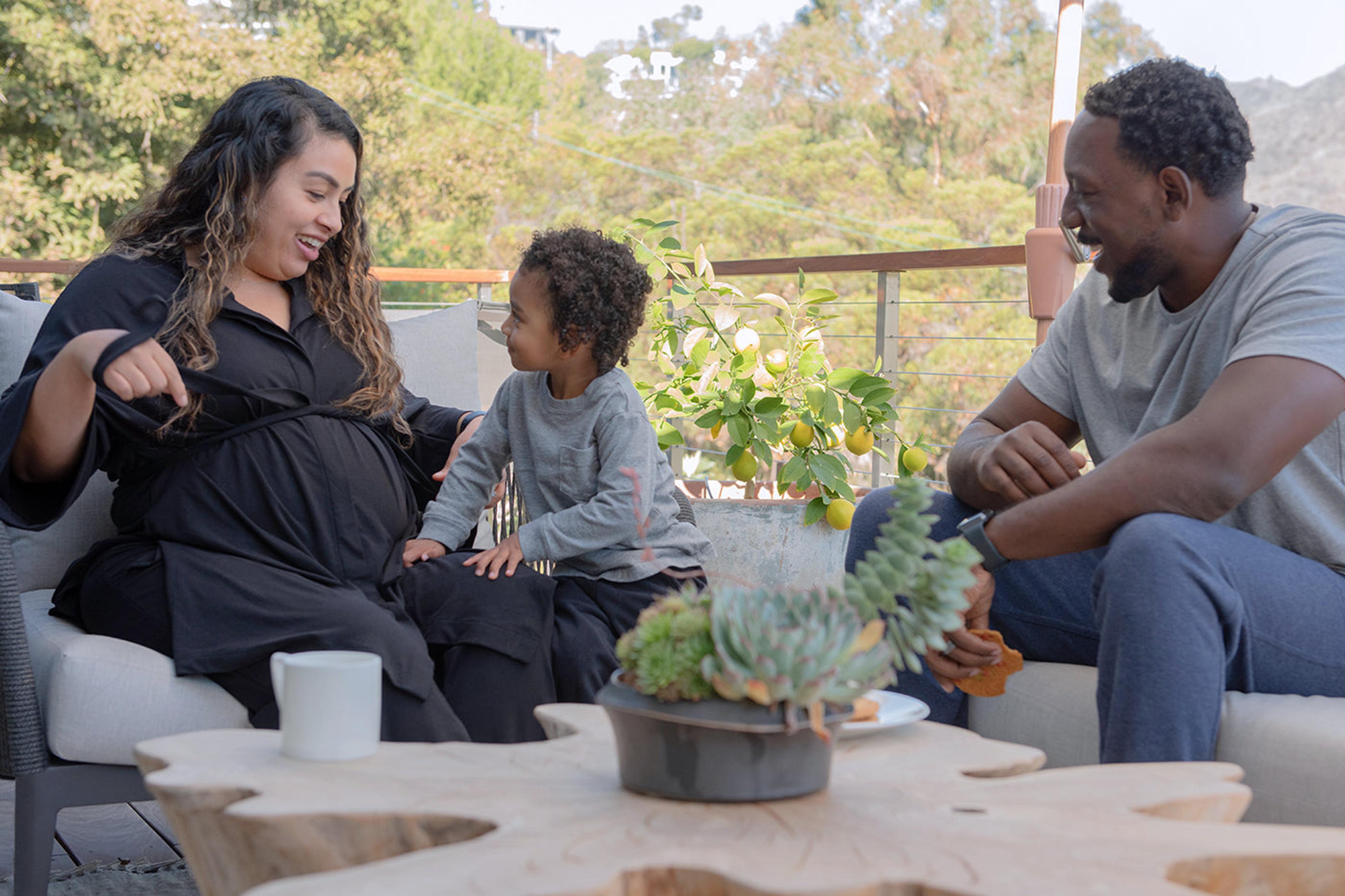 Pregnant woman outdoors with family wearing Everyday Lounge Set