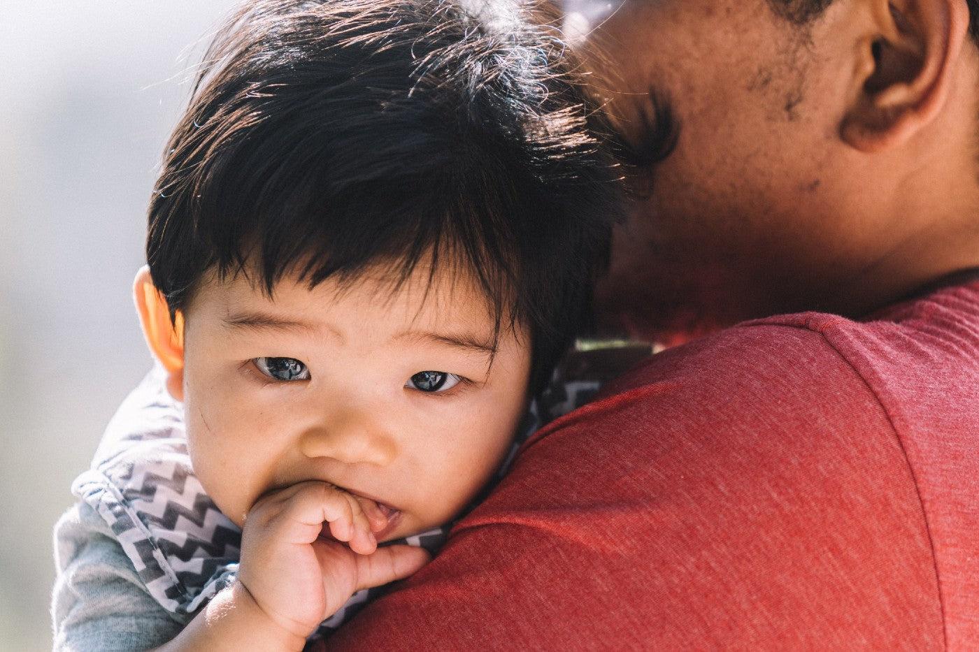 Baby boy chews on his fingers