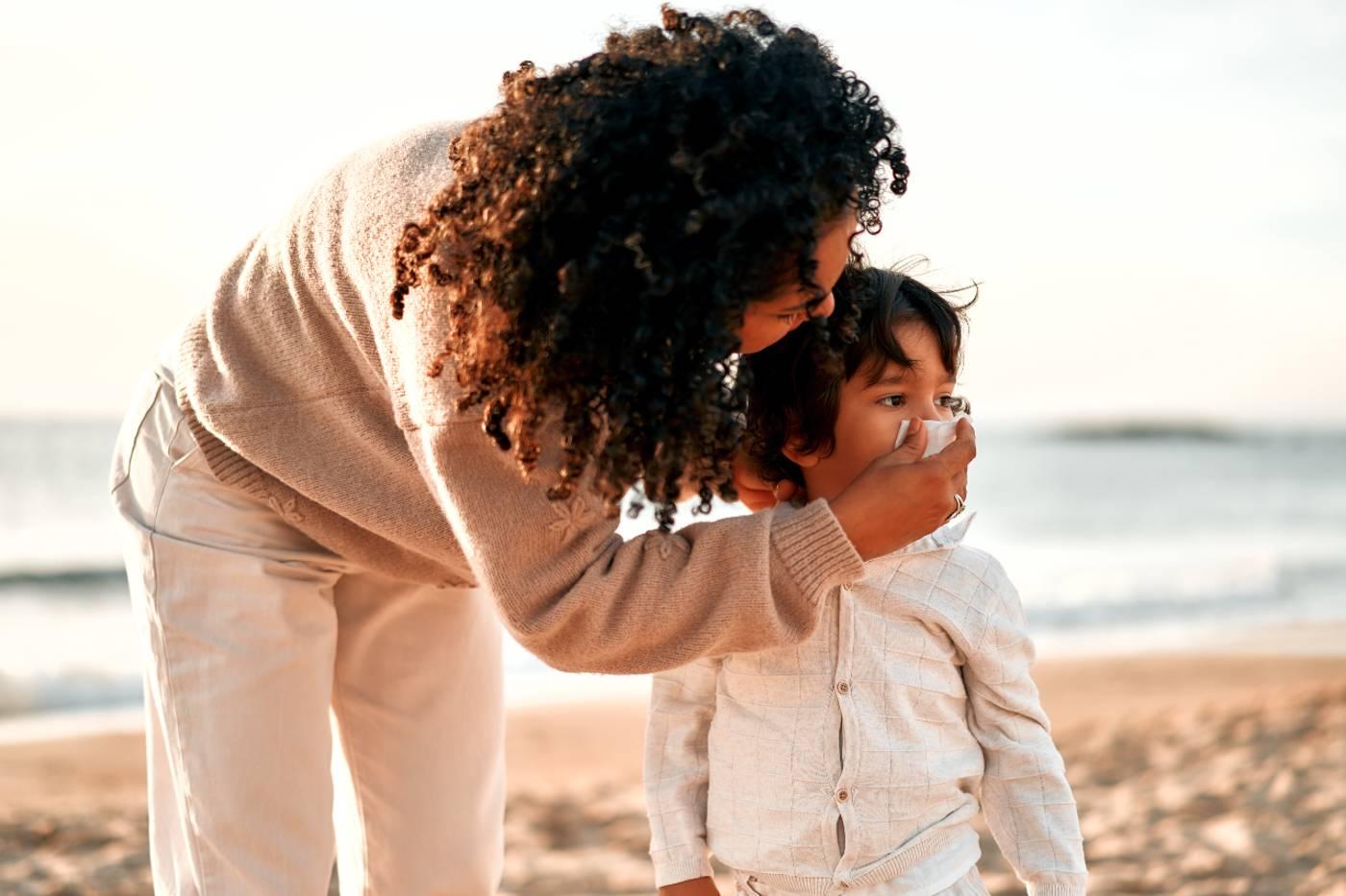 Mucus Color Meaning: mother helping child blow nose