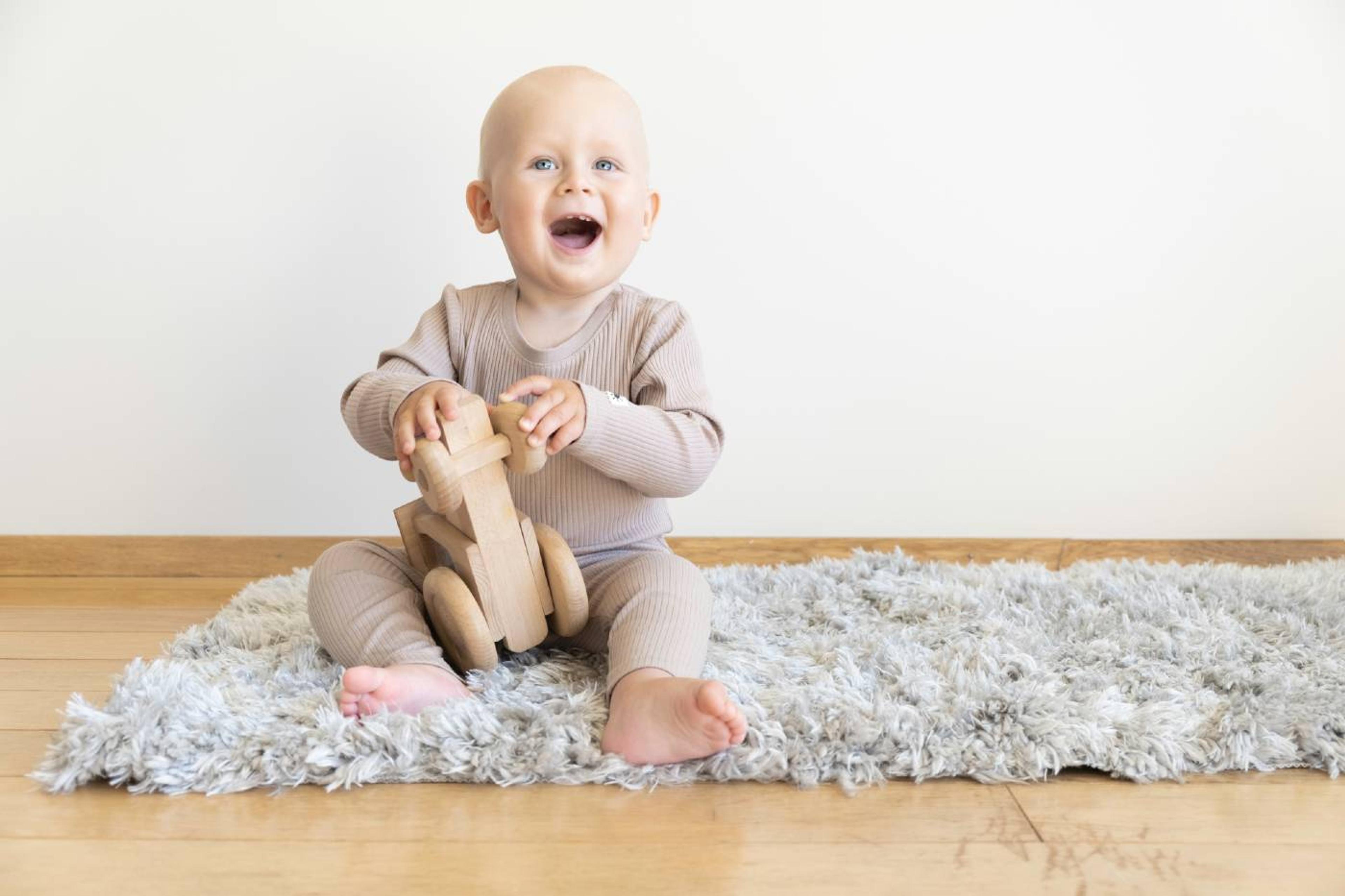 Baby playing with wooden toy