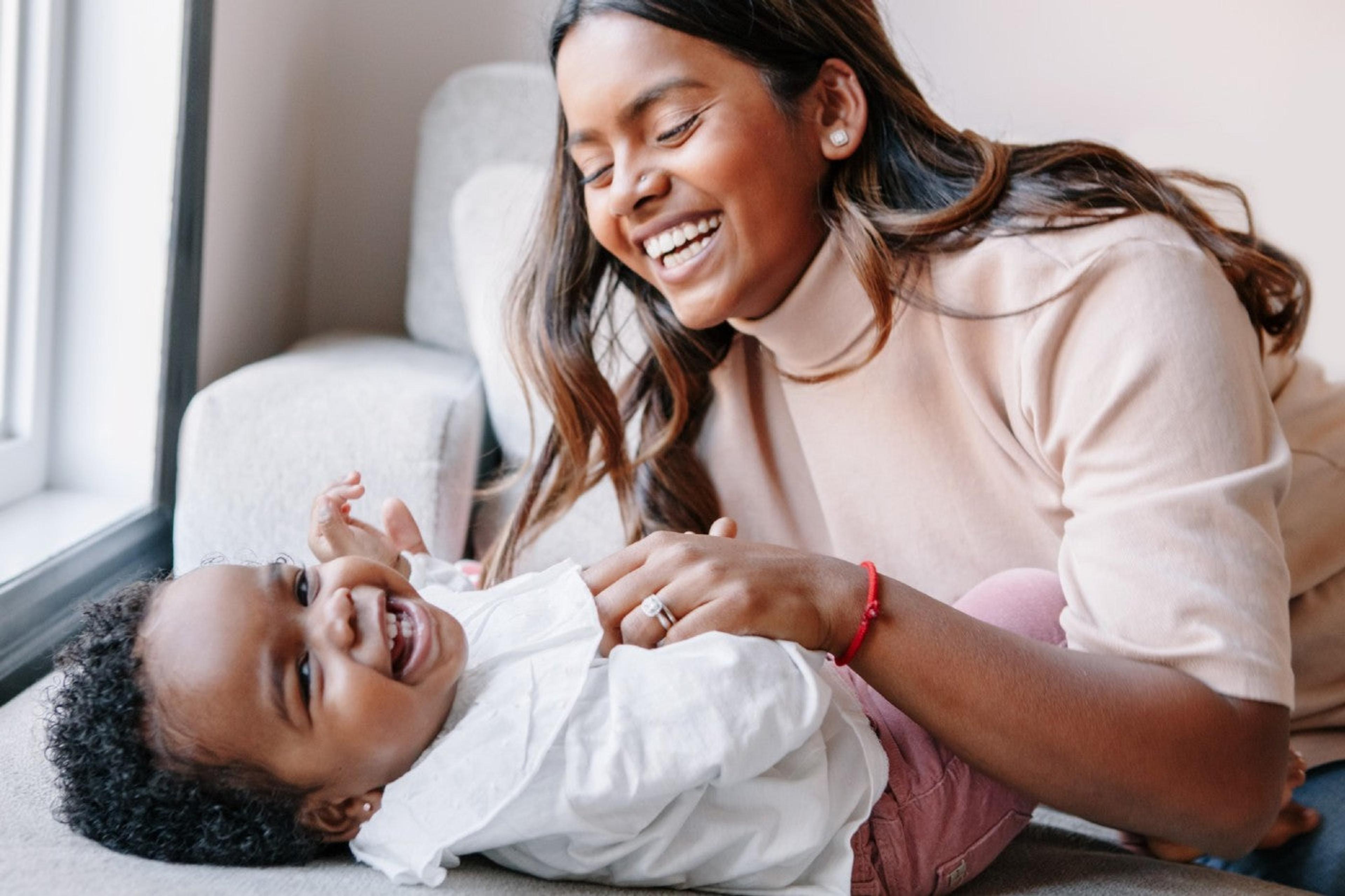 Baby laughing with mom
