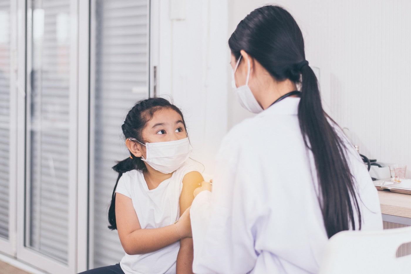 A little girl gets a vaccine