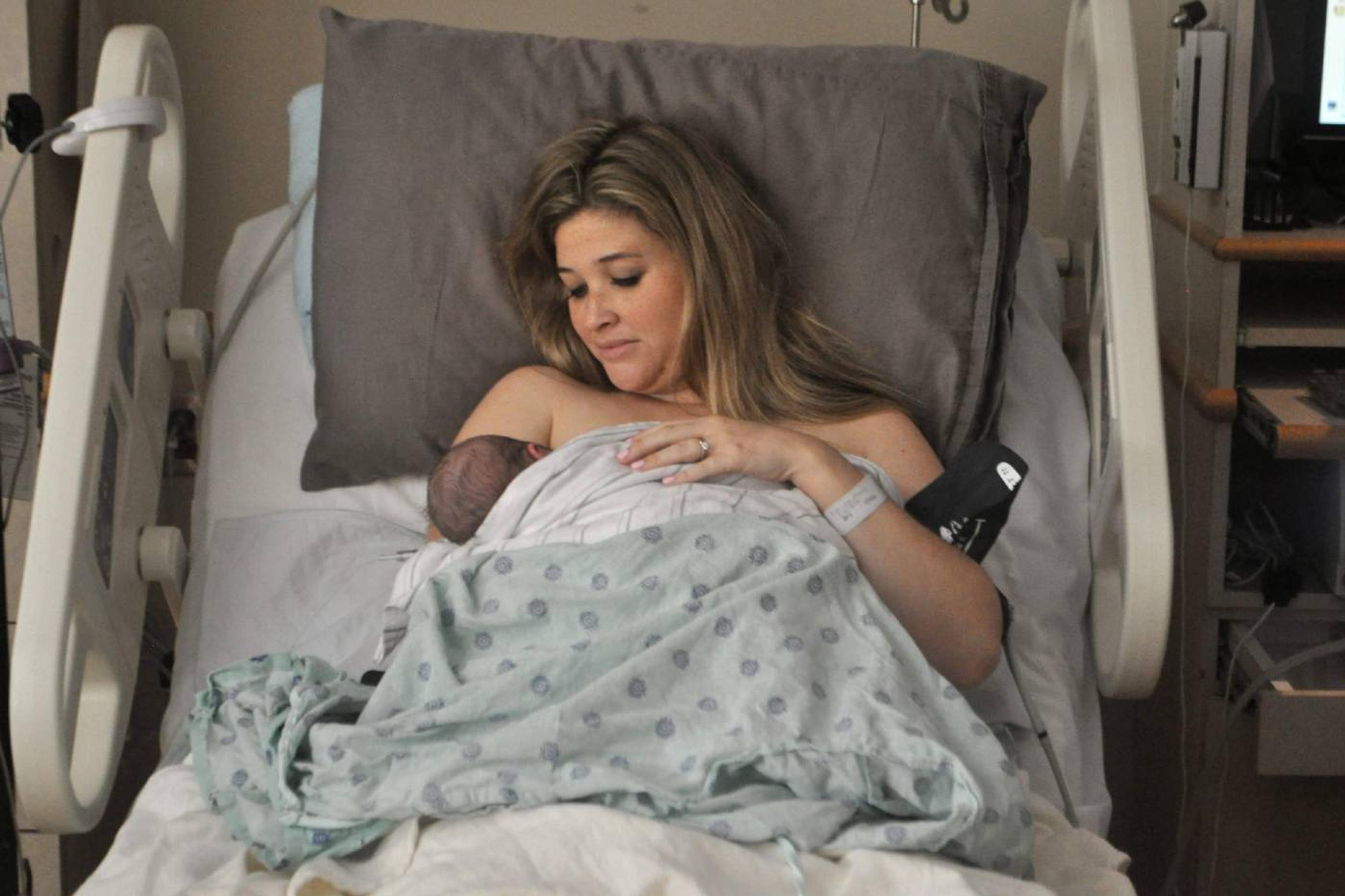A new mother cradles her newborn in the hospital