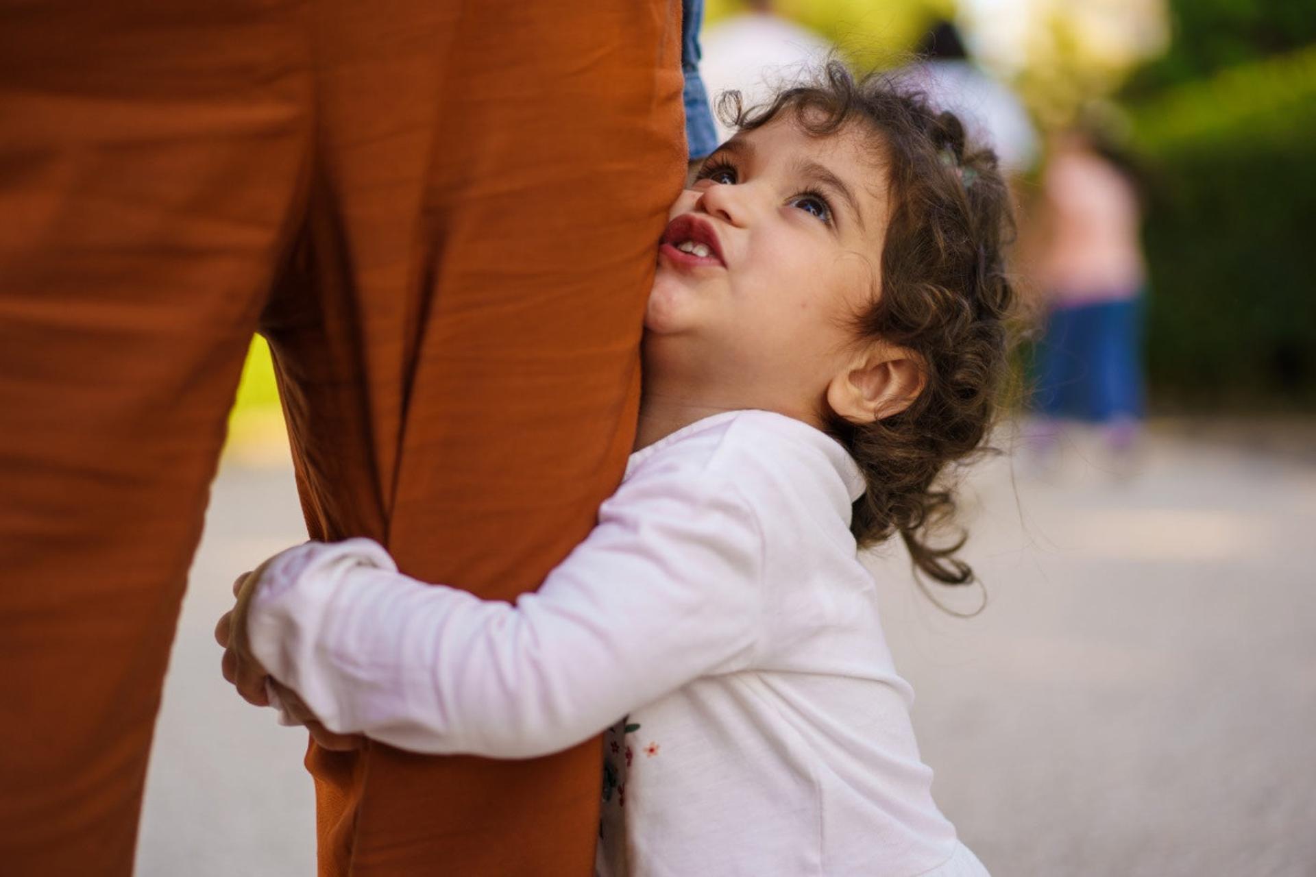 Daycare Separation Anxiety: Child holding onto parent's leg