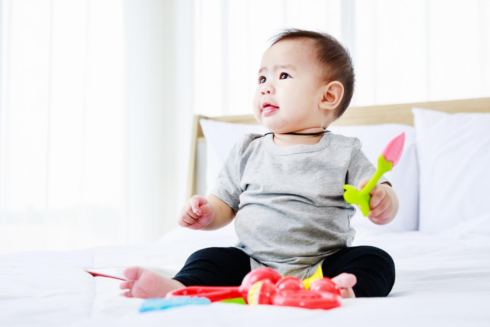 A baby plays with toys