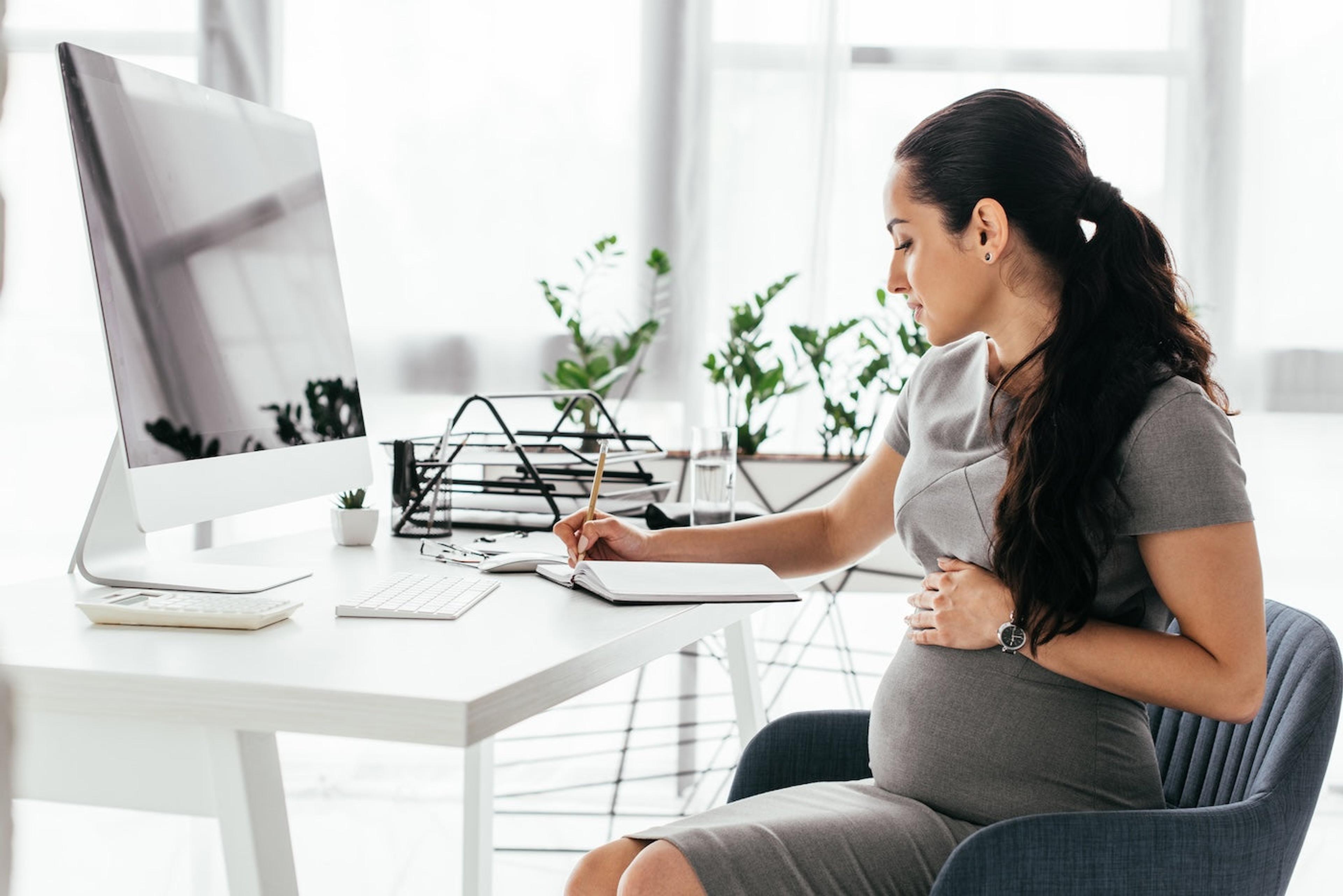 A pregnant woman makes her parental leave coverage plan at work