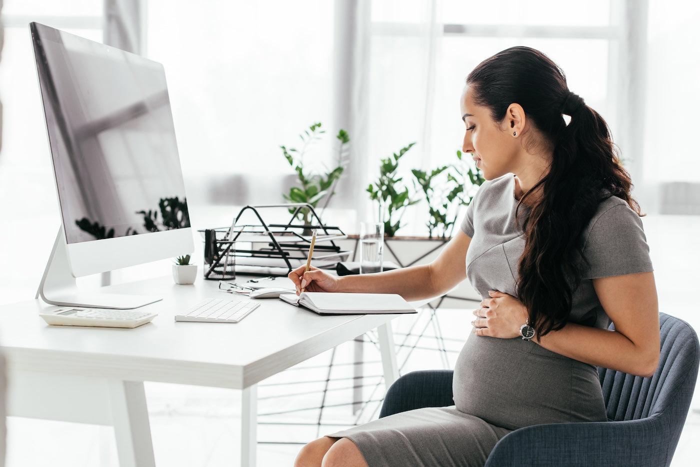 A pregnant woman makes her parental leave coverage plan at work