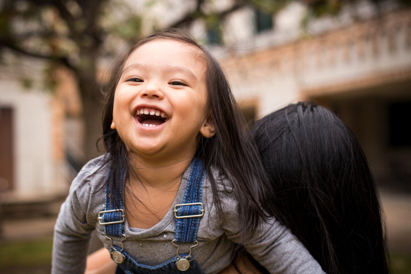 A young toddler laughs