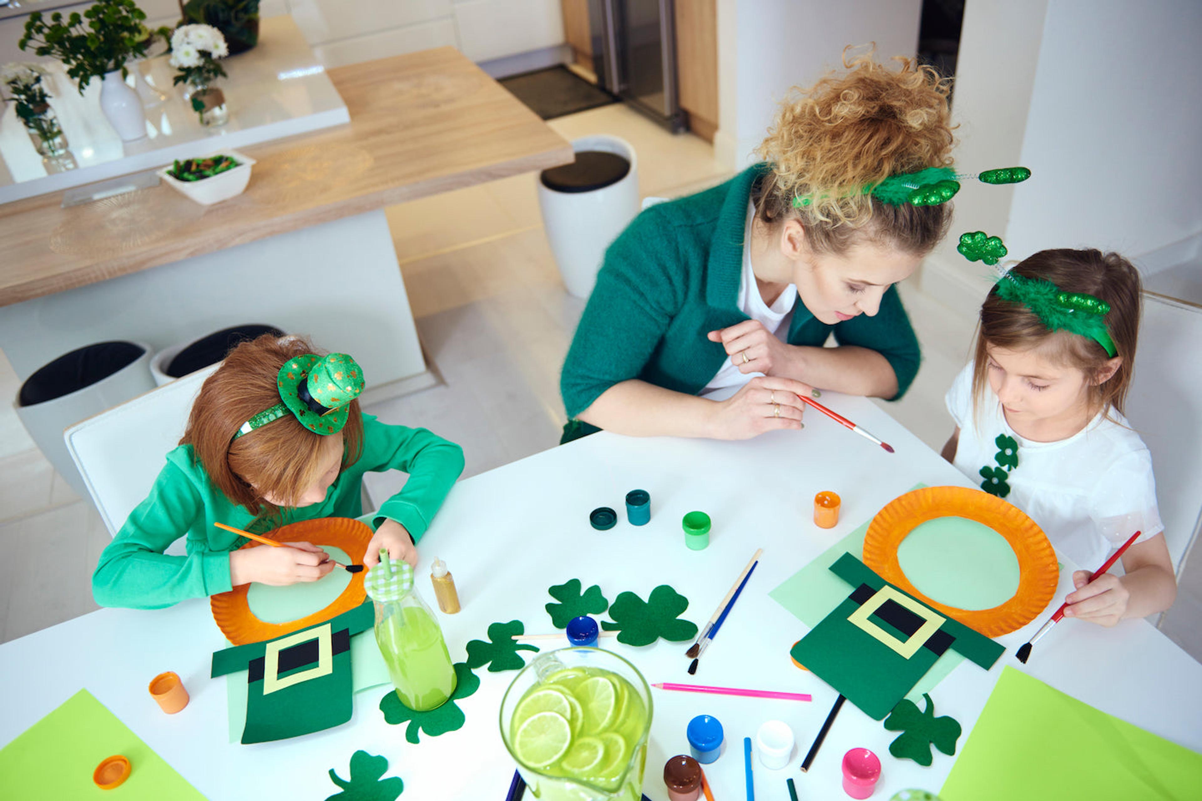 A mom does a St. Patrick's Day craft with kids