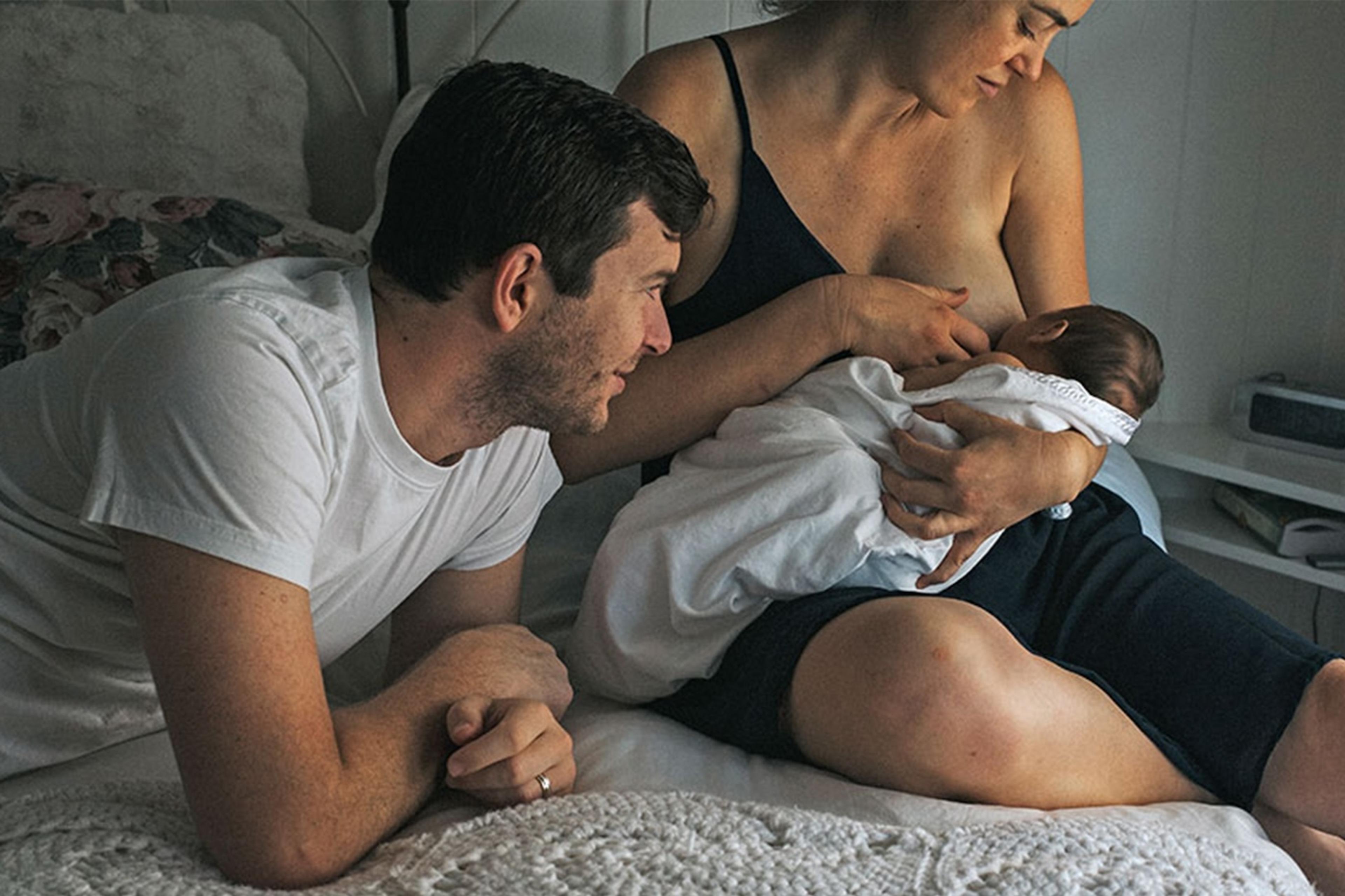 A mother gives her newborn baby a dream feed