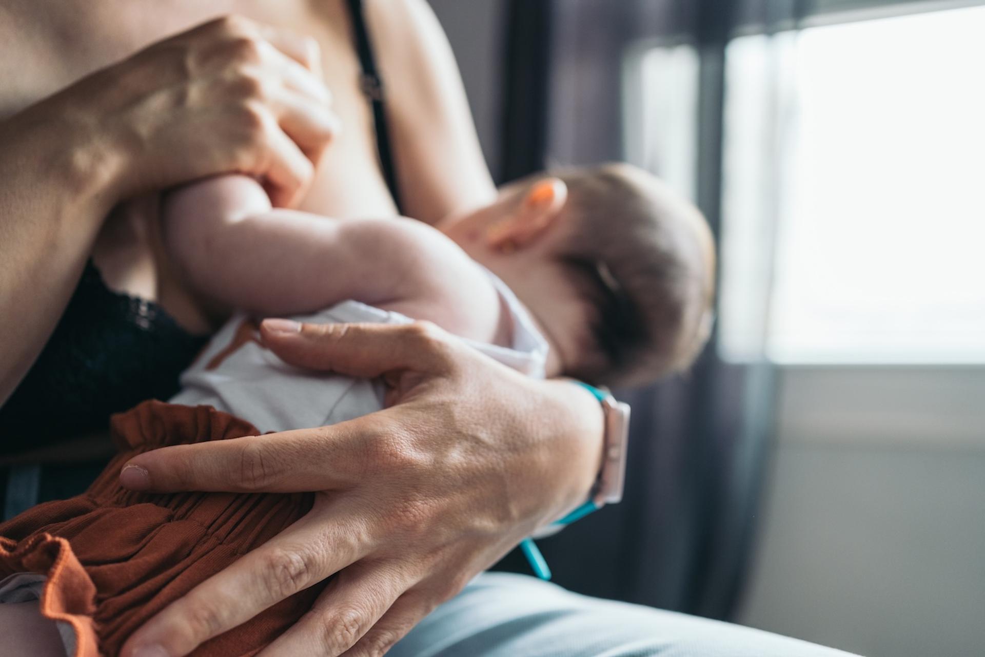 A mother breastfeeds her baby