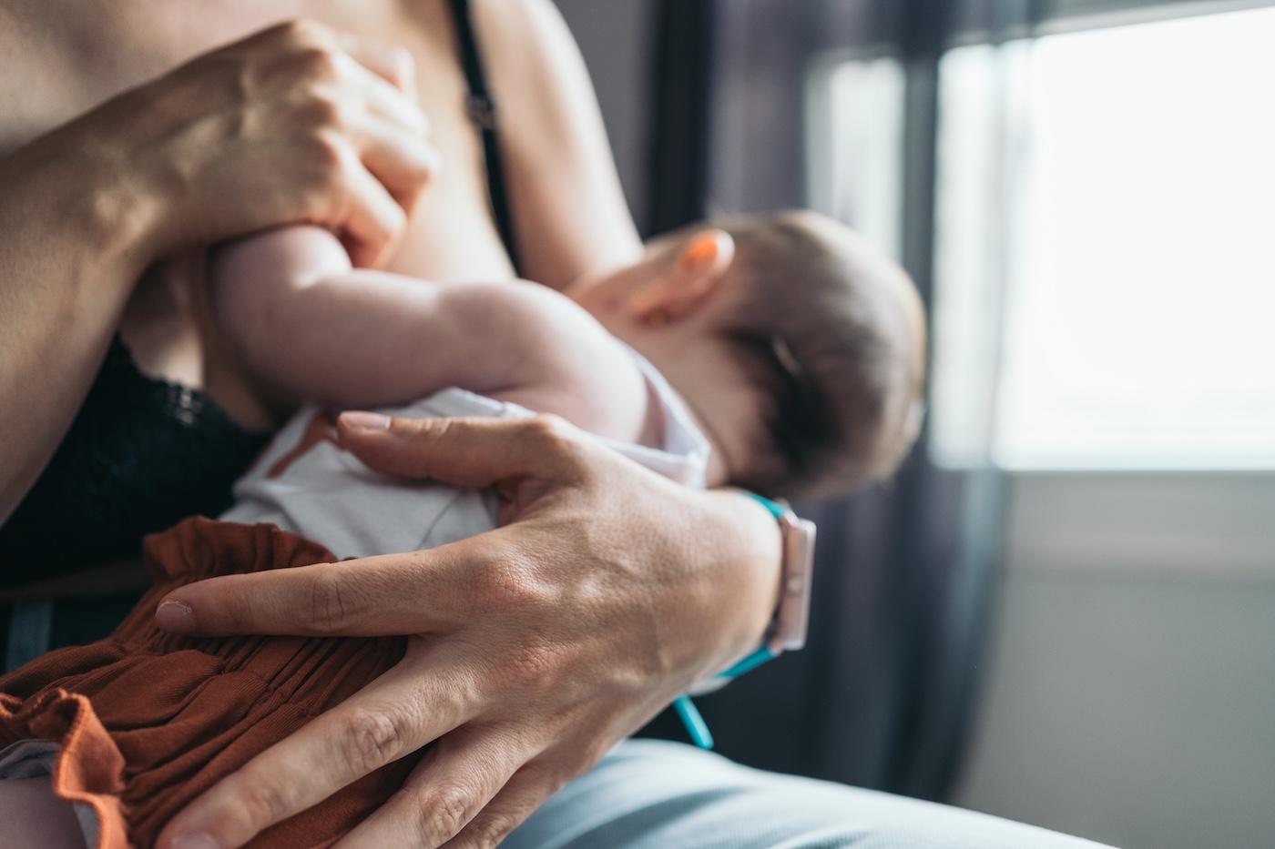 A mother breastfeeds her baby