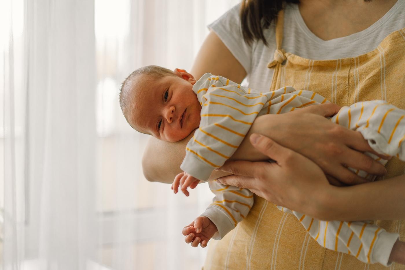 A mother holds a newborn baby