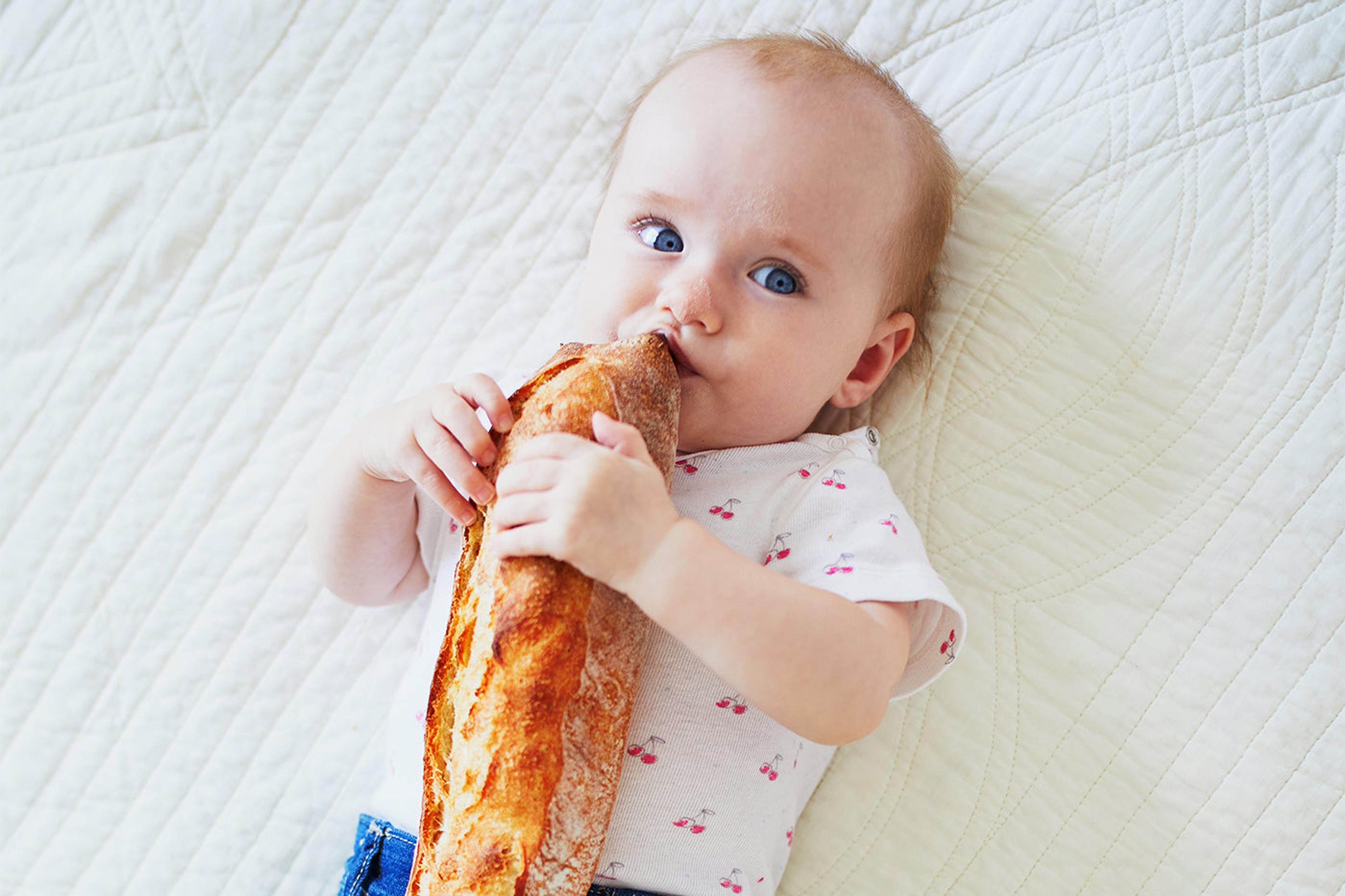 french baby eating a baguette