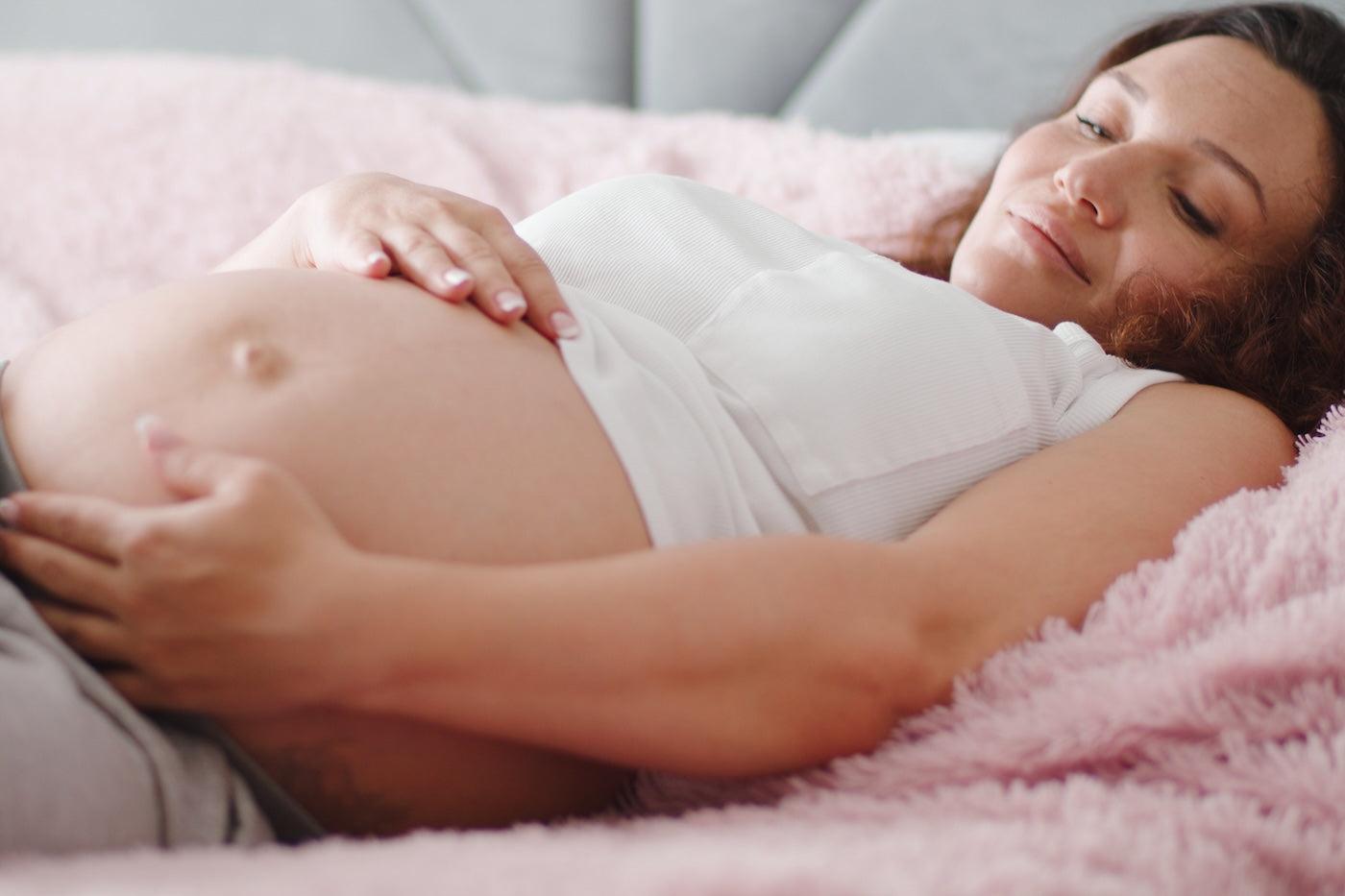 Pregnant woman coping with pregnancy bloating