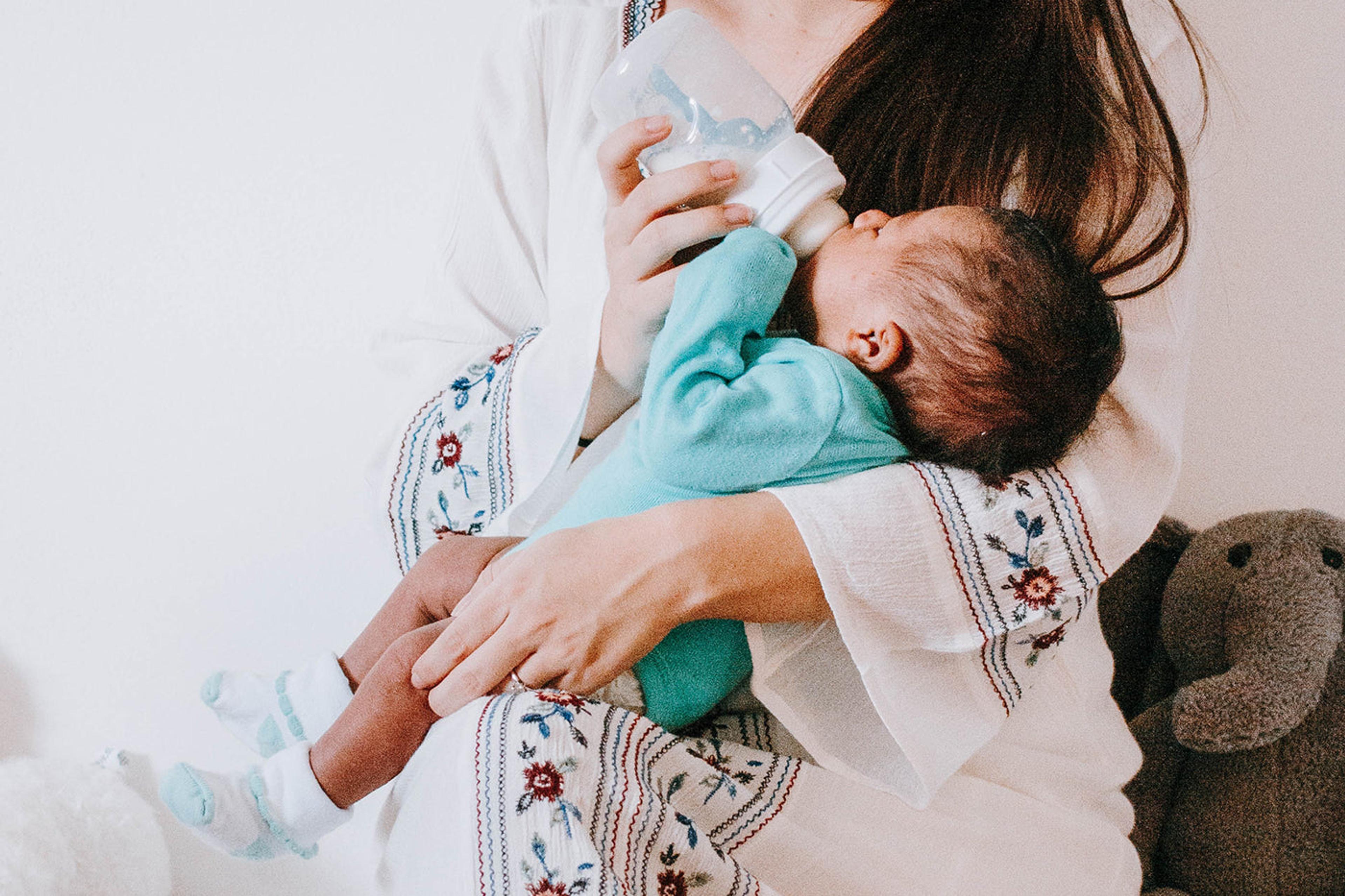 SNOO story - Sara Borden - woman bottle feeding infant