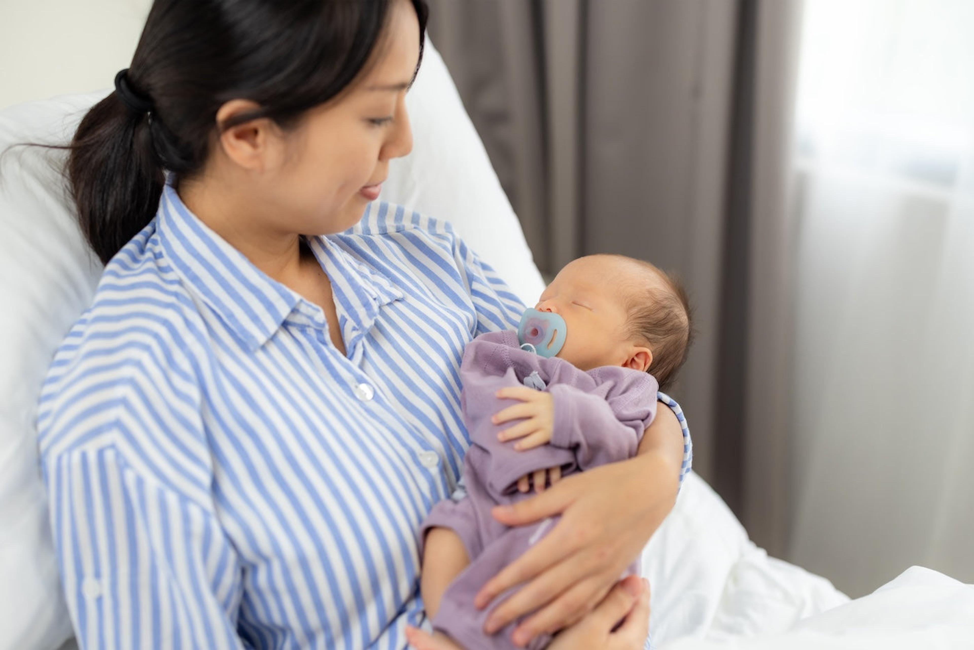 A new mother holds her newborn