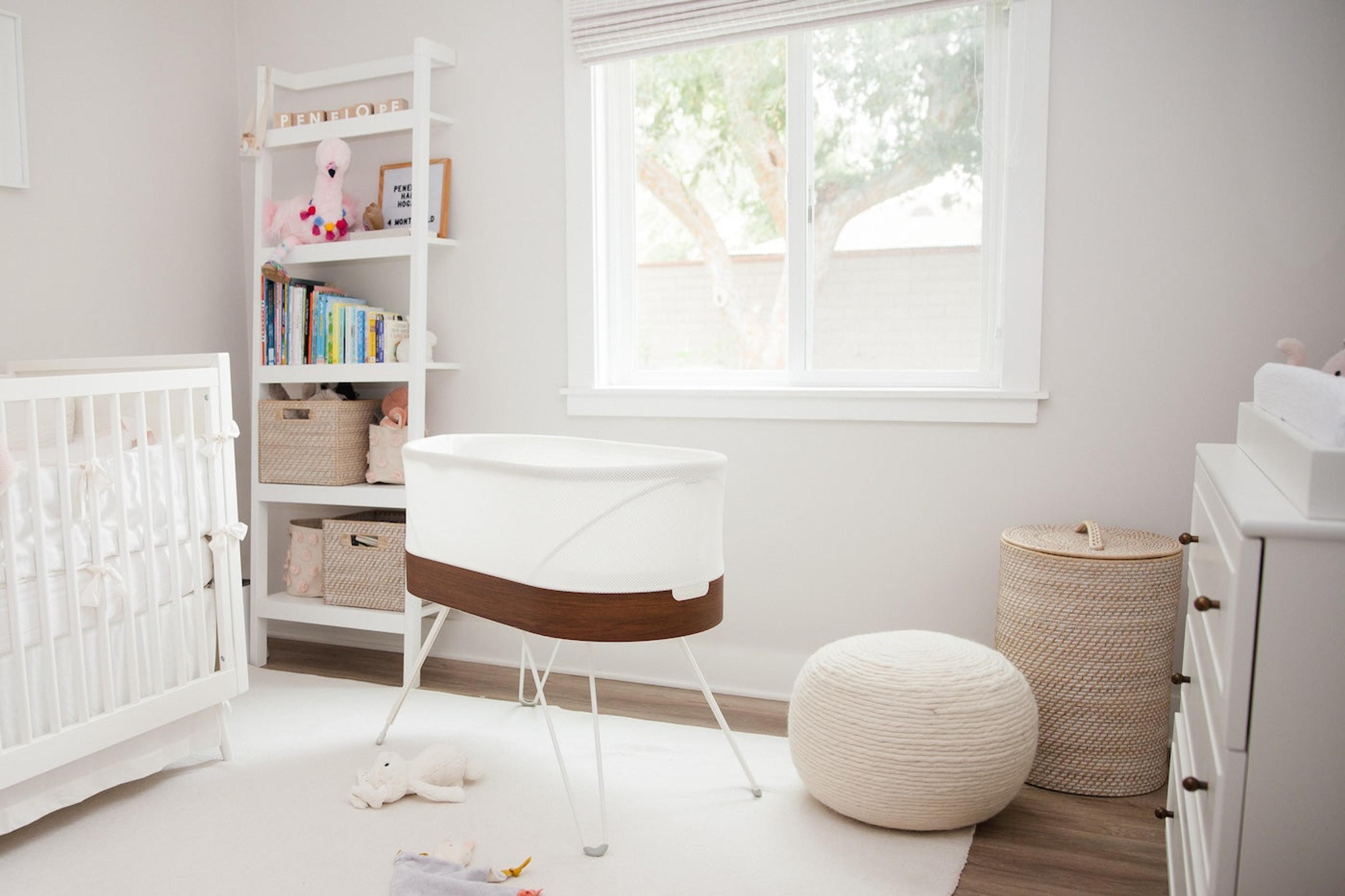 A bright clean nursery with a SNOO