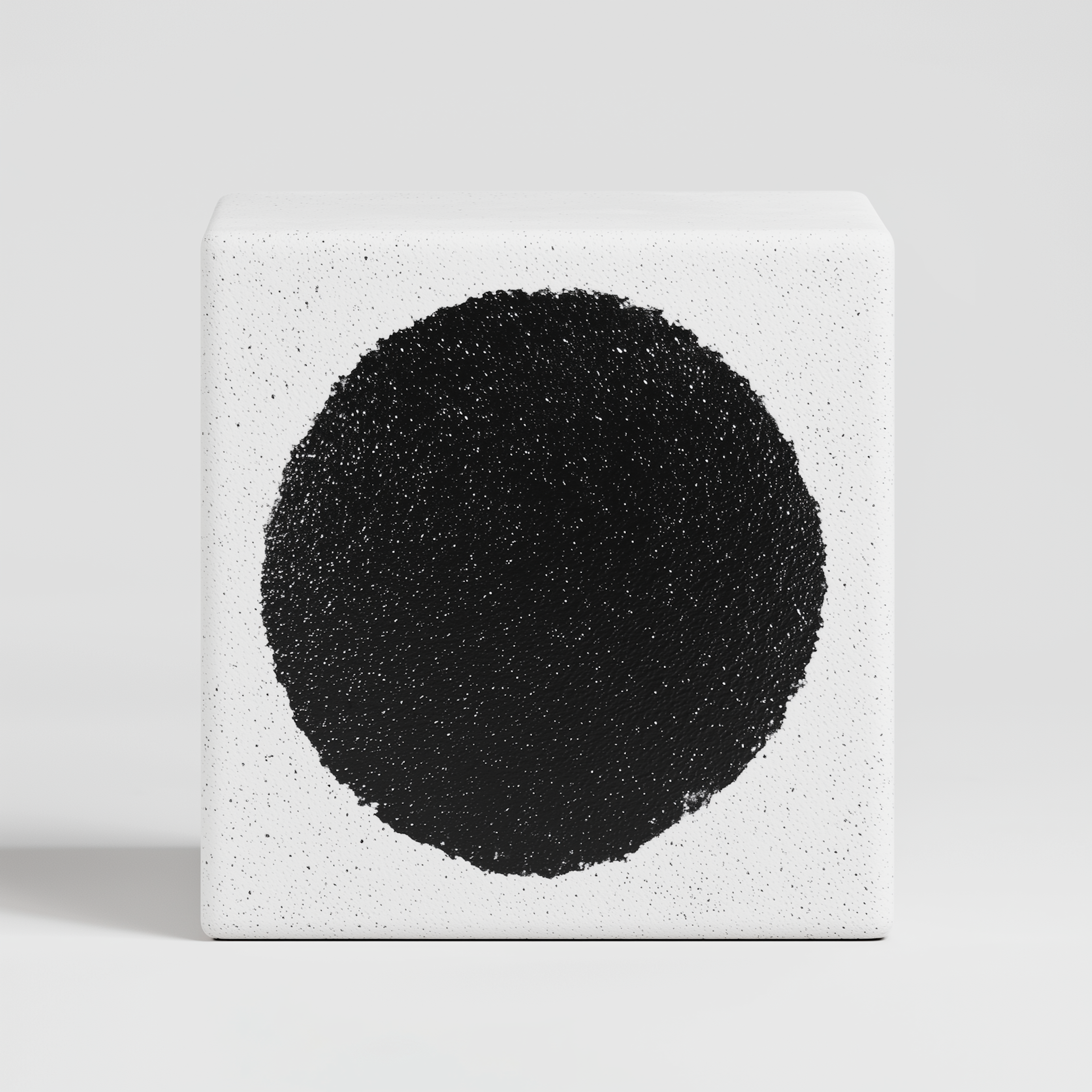 Black textured circle on a white block