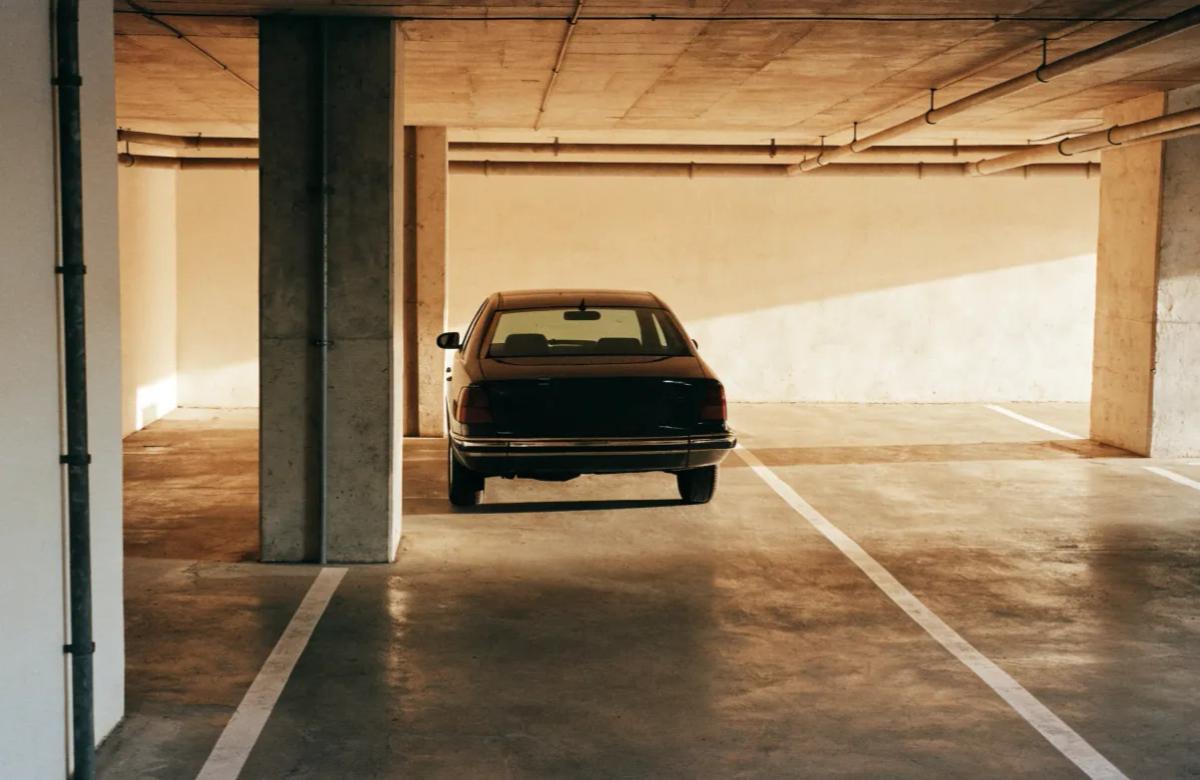 Voiture stationnée dans un parking souterrain fermé par badge en copropriété