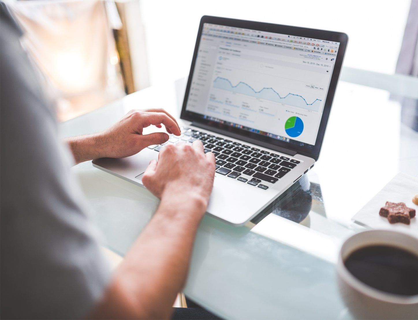 Person using a laptop displaying a marketing analytics dashboard