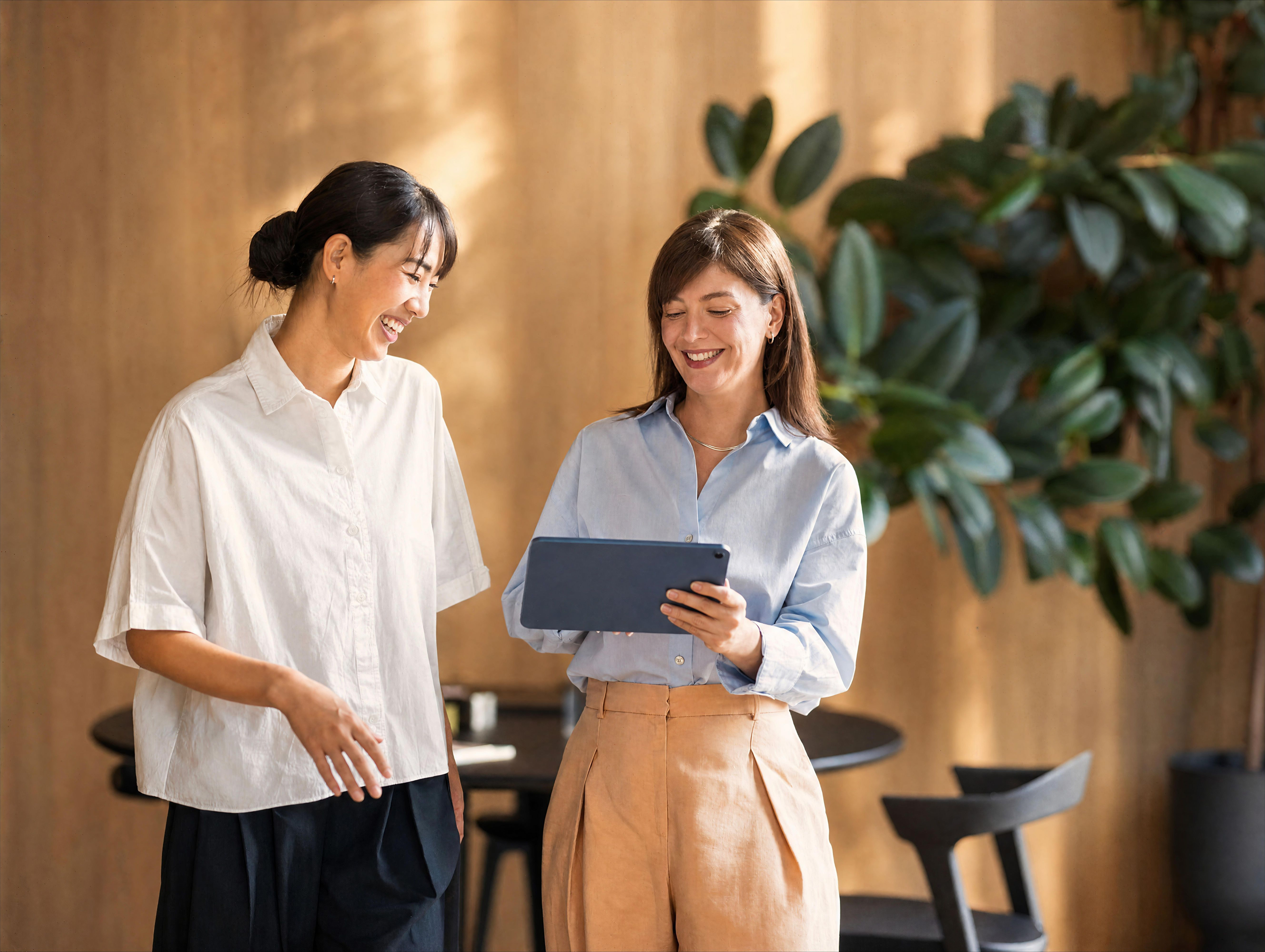 Two women looking at a tablet