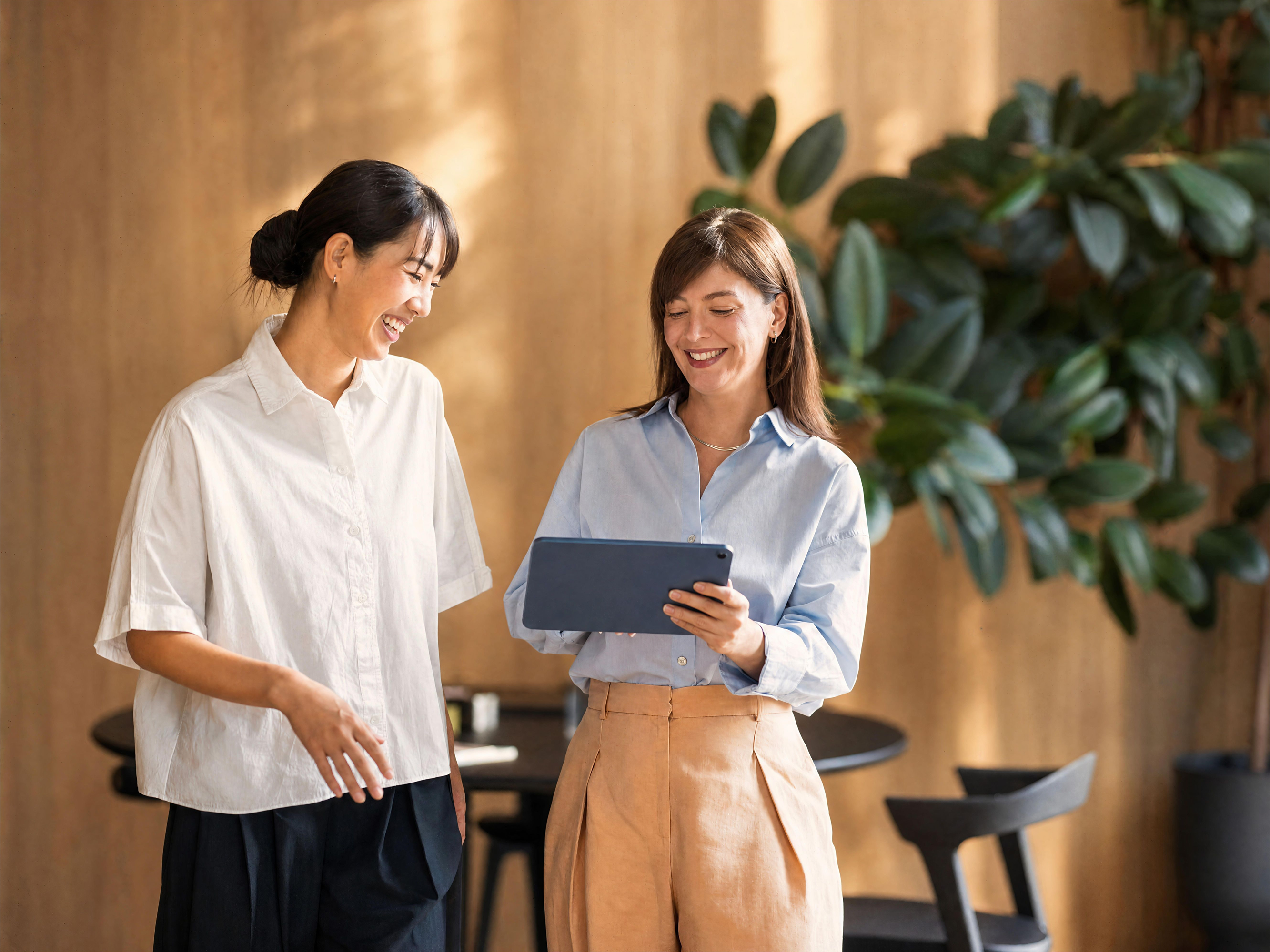 Two women looking at a tablet
