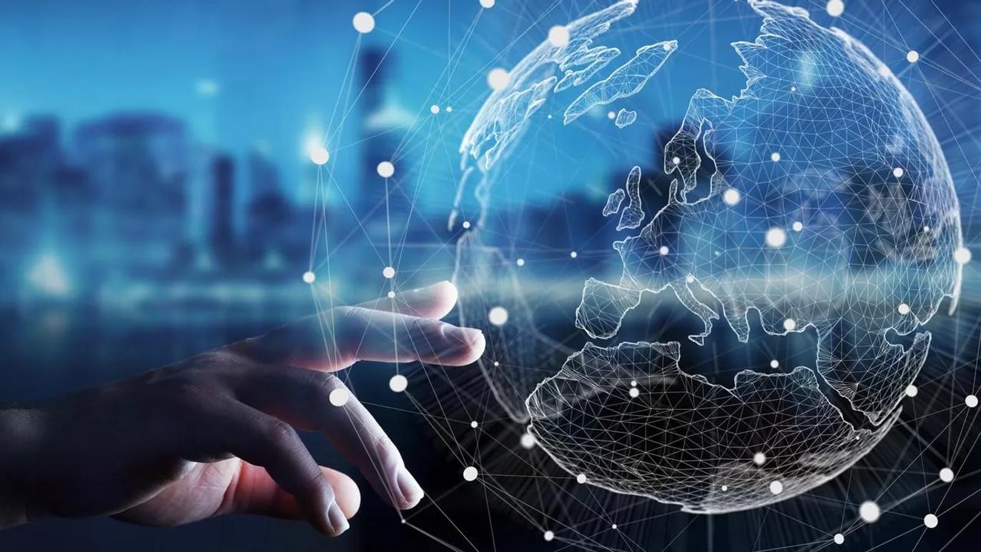A hand reaching towards a digital globe with a network of connected lines and dots, set against a blurred cityscape background.