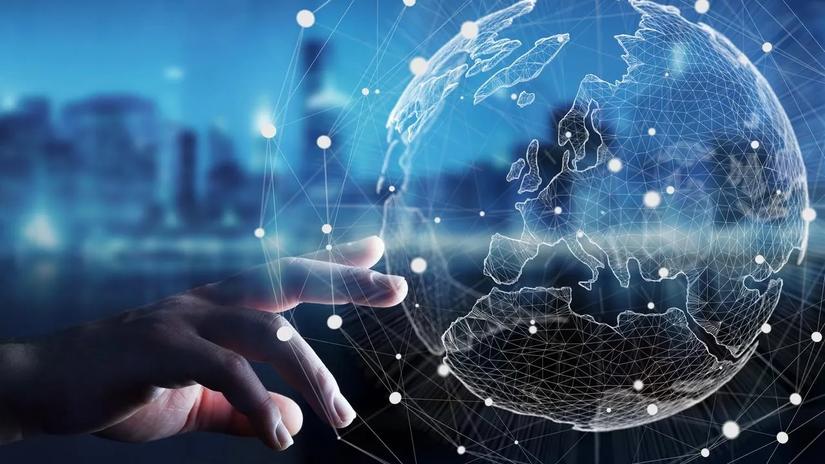 A hand reaching towards a digital globe with a network of connected lines and dots, set against a blurred cityscape background.