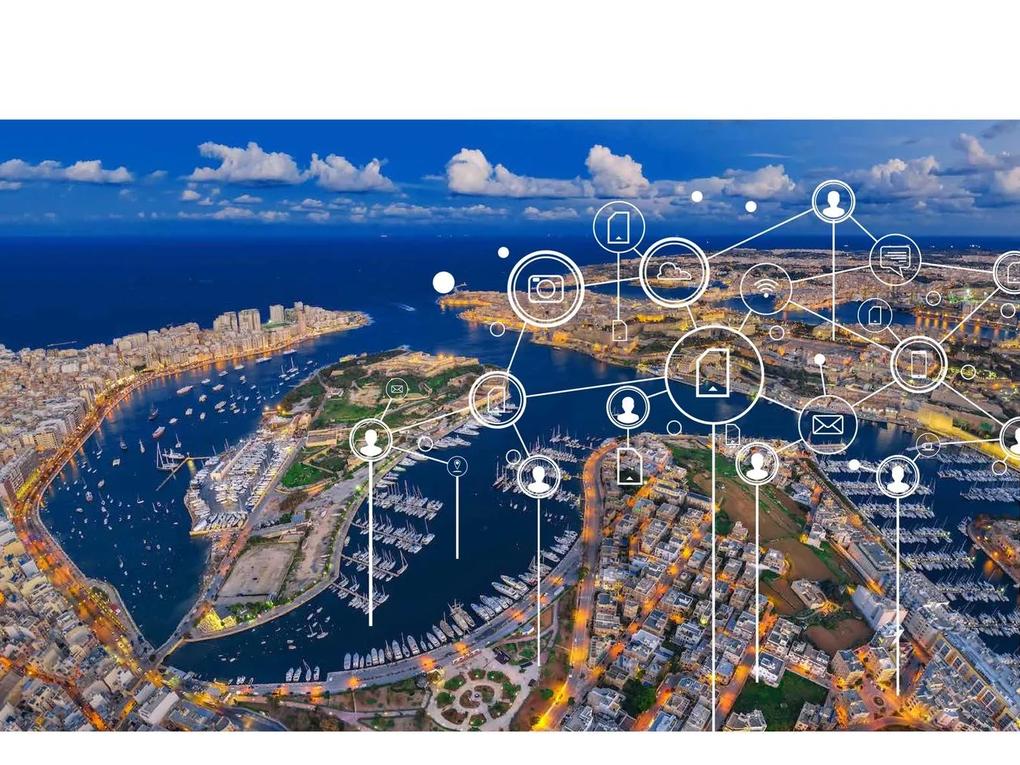 Aerial view of a coastal city with a network of digital icons overlaying the image, representing connectivity.