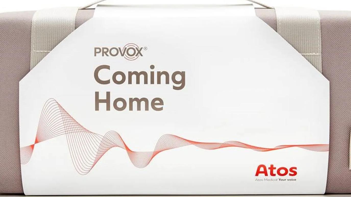 A product package labeled "Provox Coming Home" with a wave design, featuring the Atos Medical logo and the tagline "Your voice."
