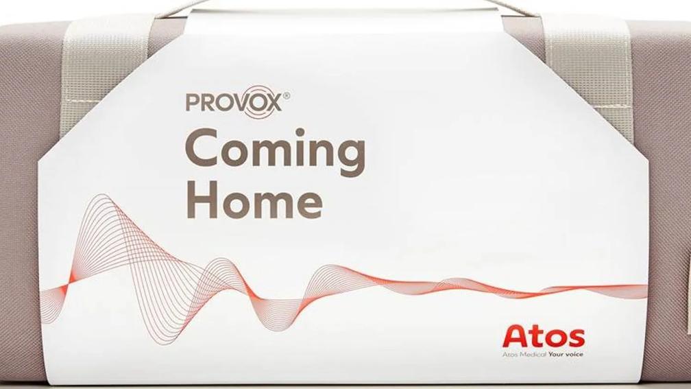 A product package labeled "Provox Coming Home" with a wave design, featuring the Atos Medical logo and the tagline "Your voice."