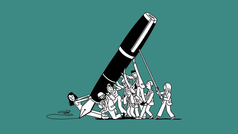 A dozen people hold up a giant pen.