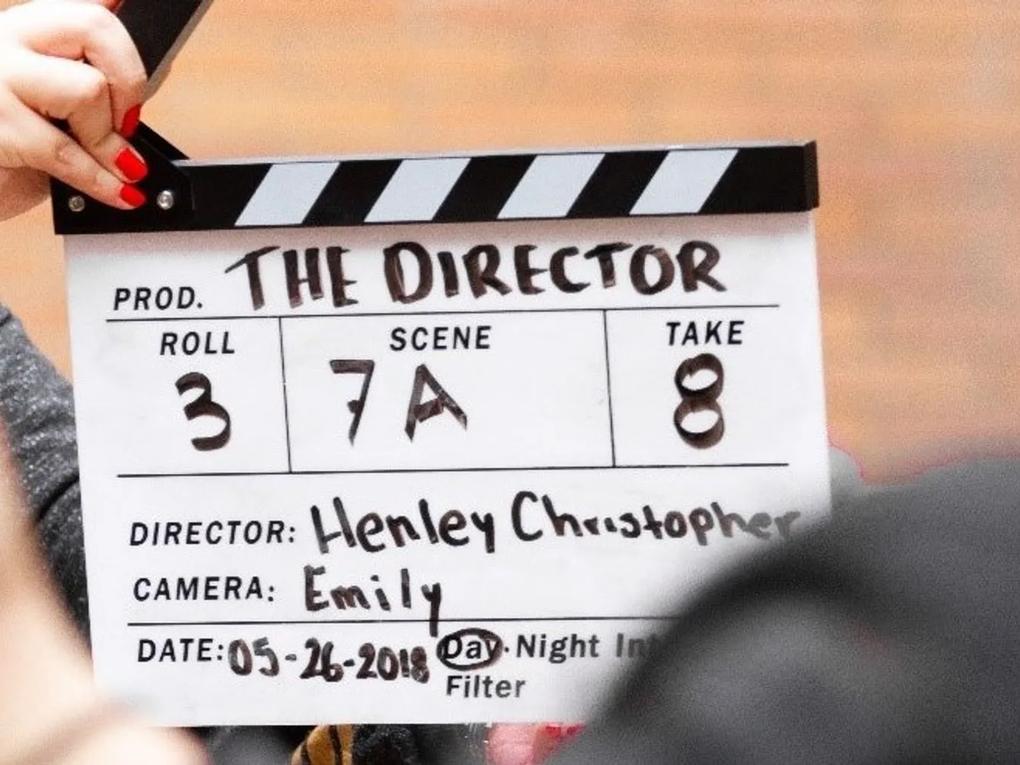 A film clapperboard labeled "The Director" with details.