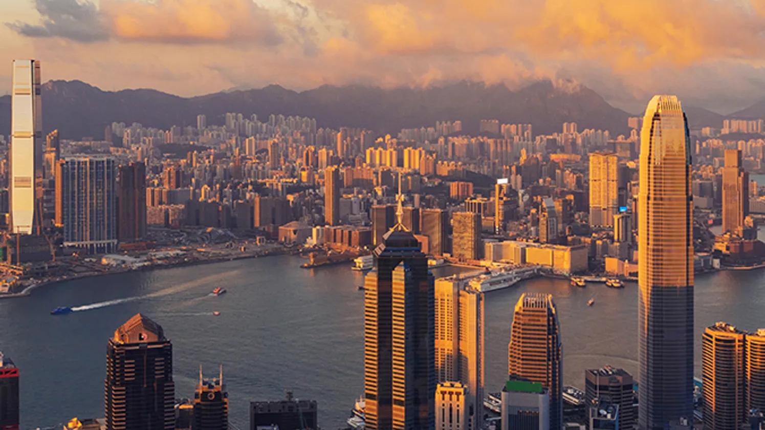 Picture of the Hong Kong skyline with cloud covered mountains in the background
