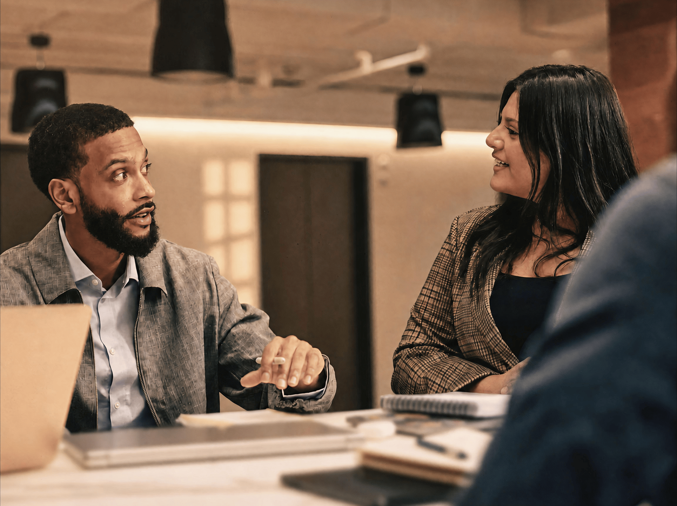 Two colleagues discussing at a table 