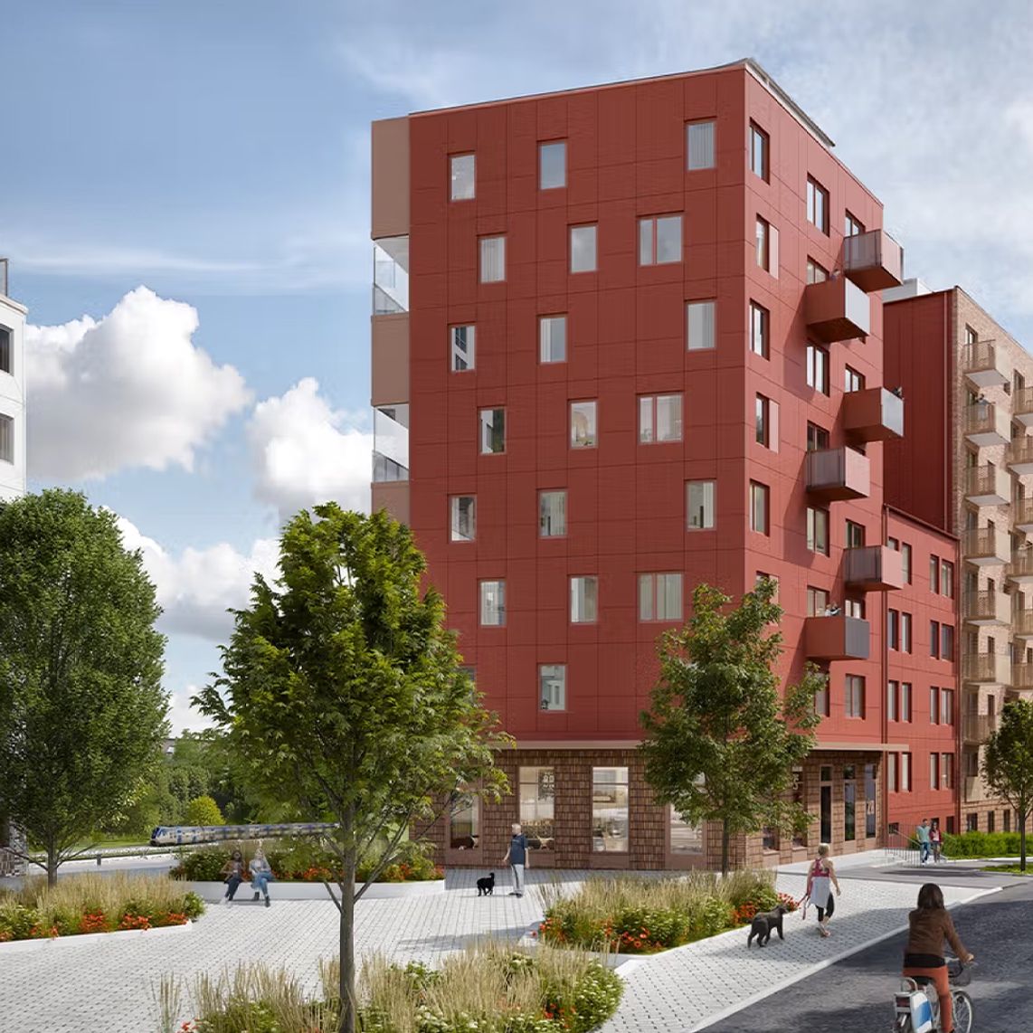 A modern residential neighborhood with red and white apartment buildings, trees, and people walking, cycling, and enjoying the outdoor space on a sunny day.
