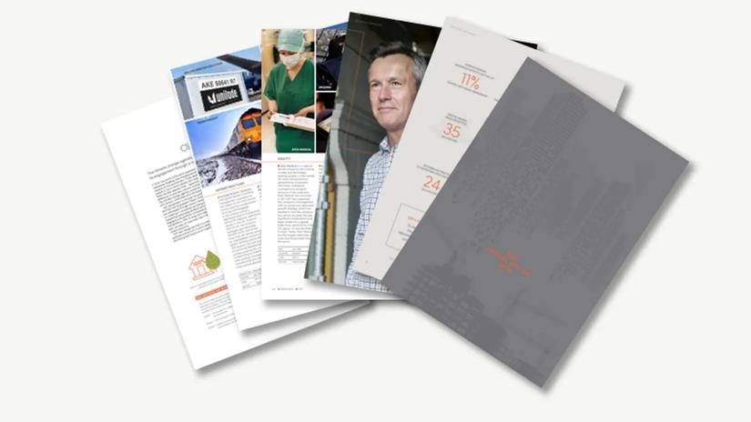 A stack of open magazines and brochures featuring various images and text, including a train, a healthcare worker, and a man in a checkered shirt.