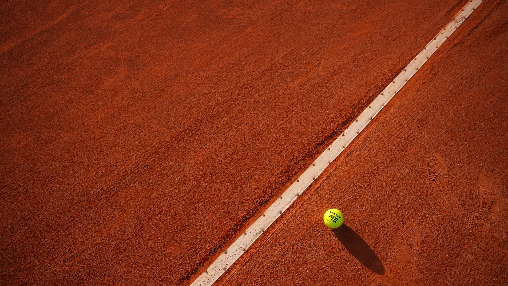 Tennis ball on clay court