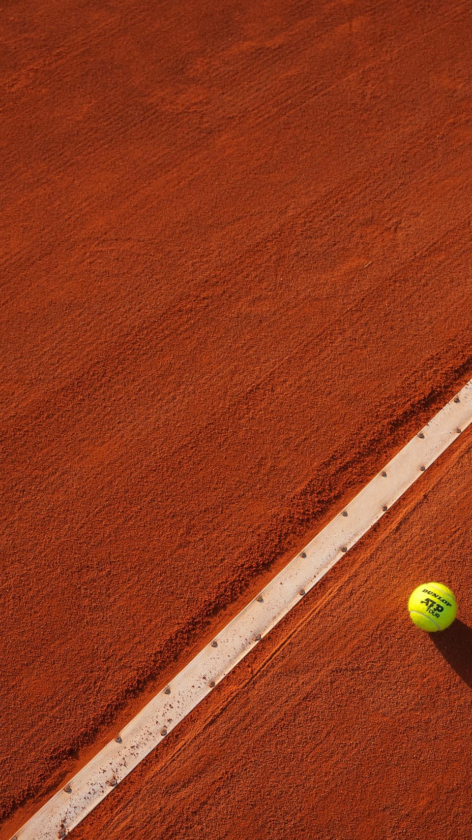 Tennis ball on clay court