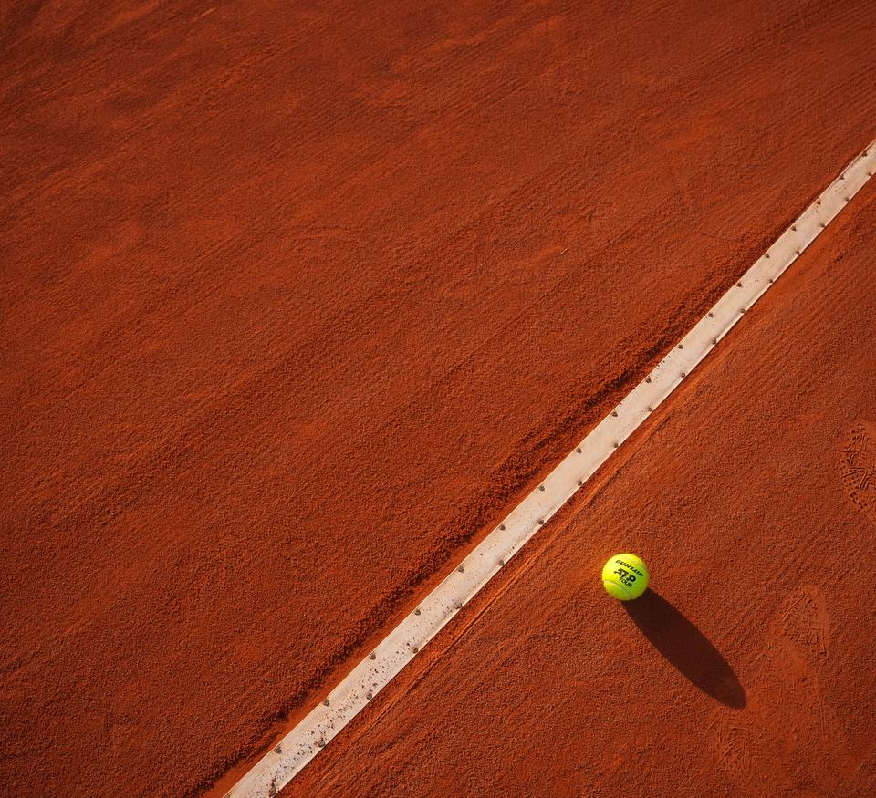 Tennis ball on clay court