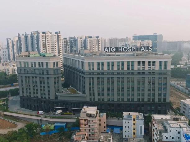 A large building labeled "AIG Hospitals" is in the foreground, surrounded by smaller buildings and high-rise apartments in the background.