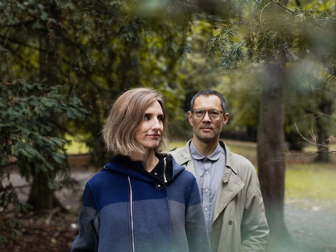 Two people wondering around in a park.