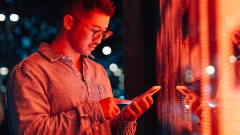A man looks at his phone