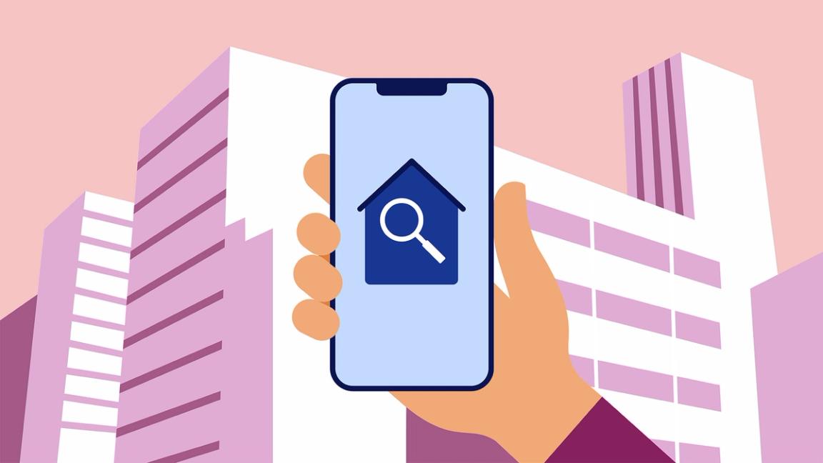 A hand holds a smartphone in front of a cityscape.