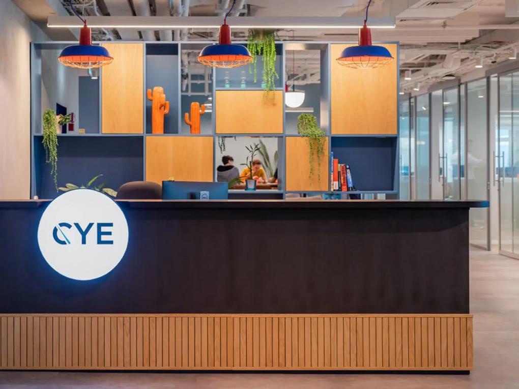 A modern office reception area with a desk labeled "CYE."