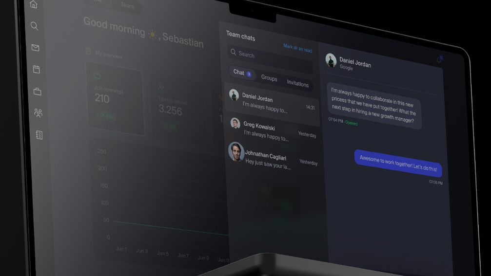 A laptop screen shows a team chat.