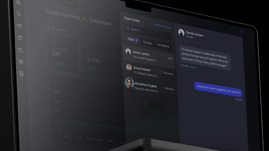 A laptop screen shows a team chat.